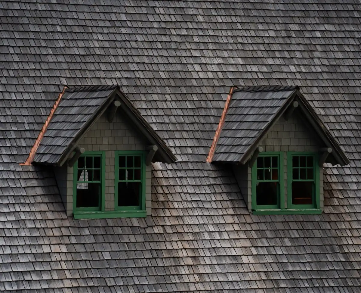 Dormers on a shingle roof in Lafayette, LA, where step flashing and kickout flashing carry water past the walls